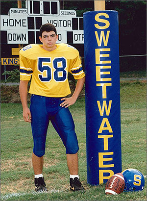 Joey Hunt in football uniform standing beside Sweetwater, TN goal post